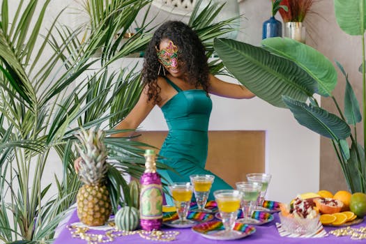 A festive masquerade party with a colorful mask, tropical fruits and drinks, captured indoors.