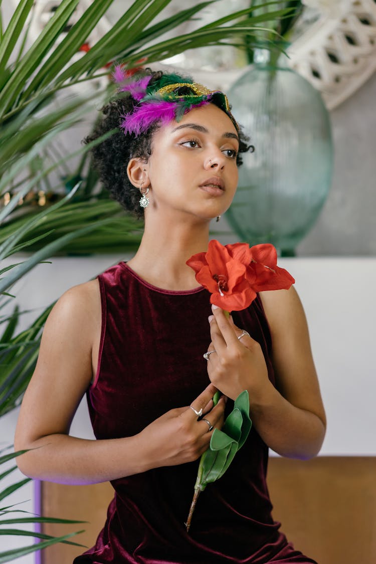 Woman In Maroon Tank Dress Holding Red Flower