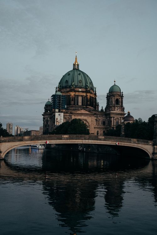 Free Magnificent view of the Berlin Cathedral with its reflection in the river, showcasing architectural beauty at dusk. Stock Photo