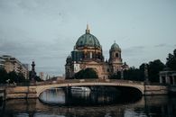 Brown and Green Dome Building Near Body of Water