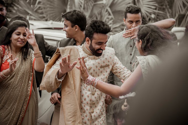 People In Traditional Indian Clothing Dancing At A Party 