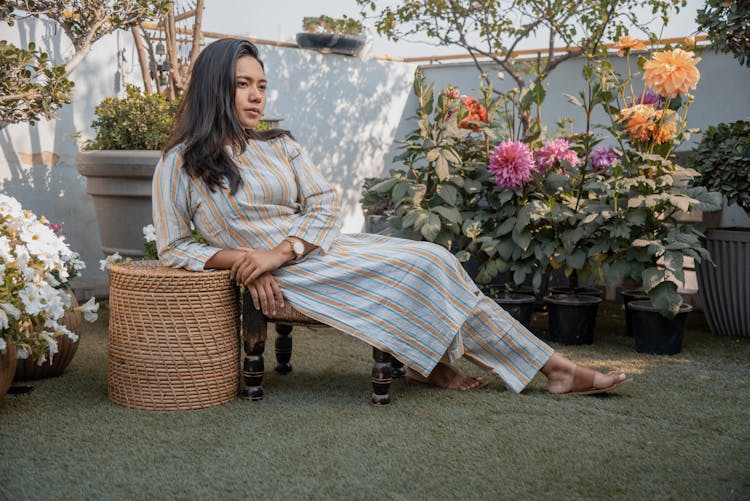 Portrait Of A Pretty Brunette Relaxing In A Balcony Garden