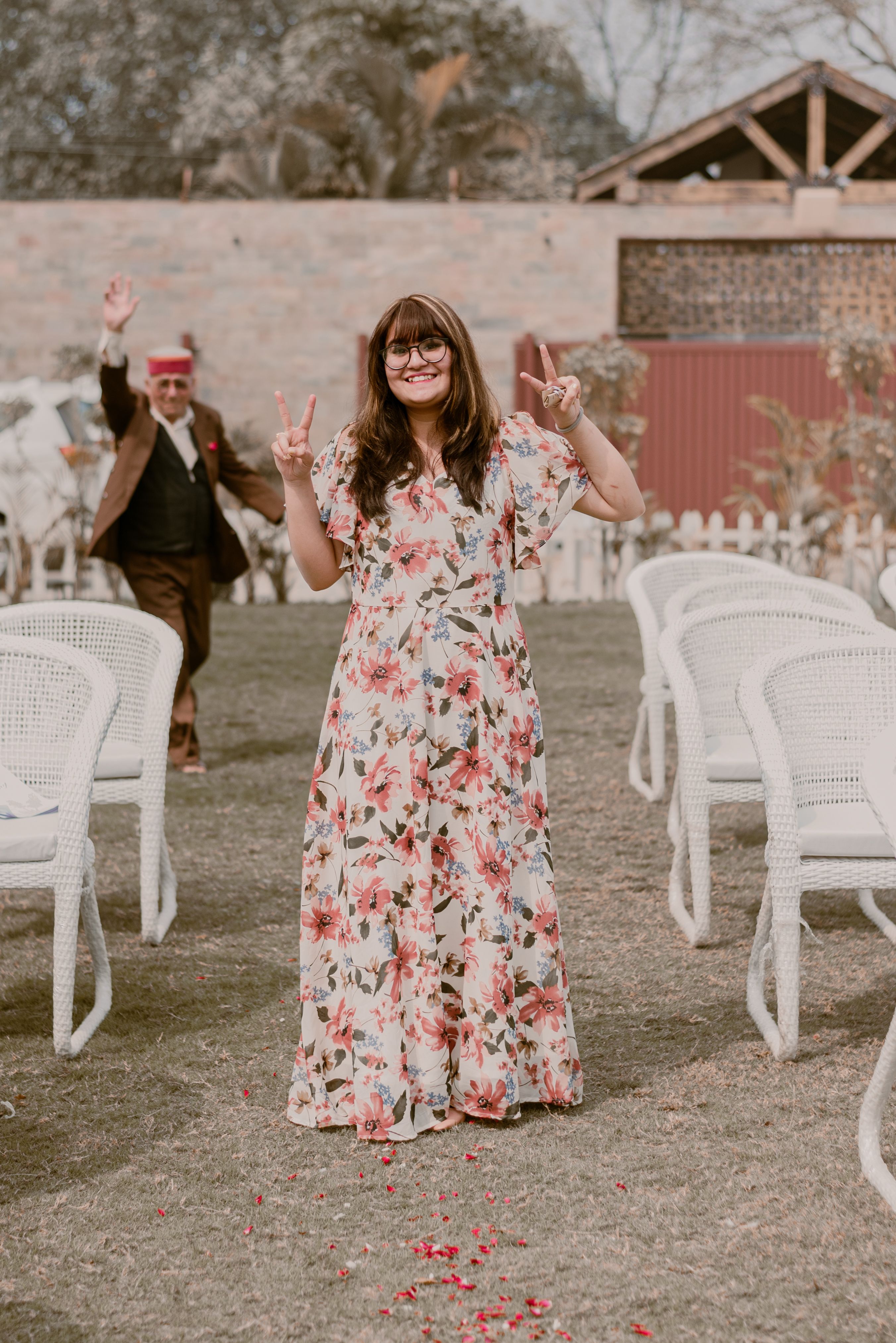 A Woman in Red Floral Dress Standing near Flowers · Free Stock Photo