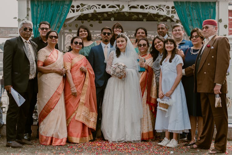 Bride And Groom Posing With Their Families