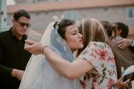 A Woman Kissing a Bride