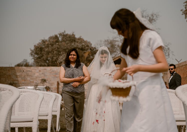 Mother And Bride Walking On Aisle