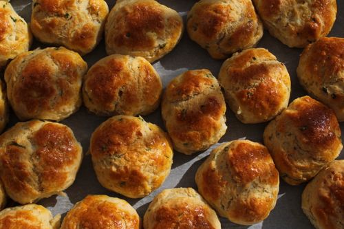 Free Delicious golden brown biscuits freshly baked and arranged on a tray under warm lighting. Stock Photo