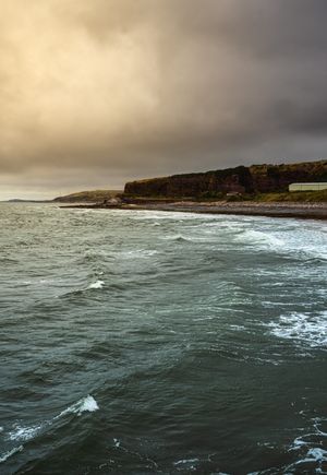 Rugged coastline under cloud by Murry Lee on Pexels