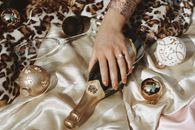 Person Holding Brown Glass Bottle
