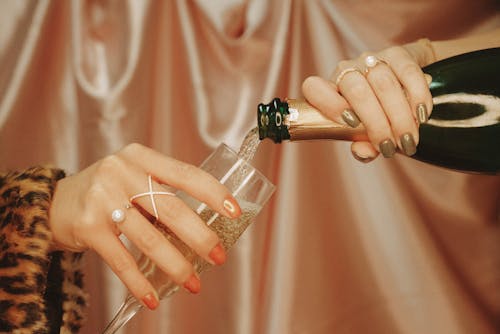 Person Holding Clear Drinking Glass