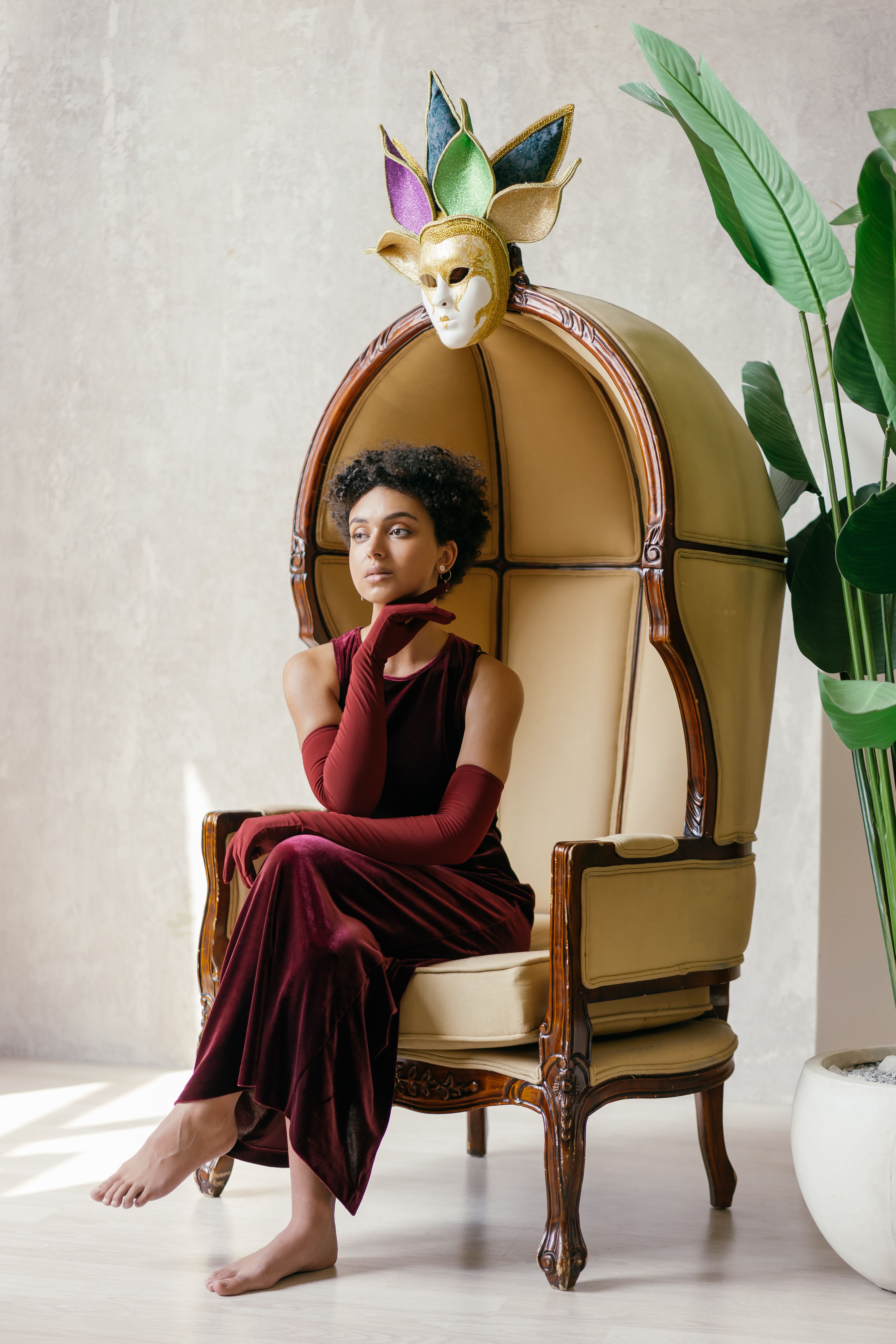 Woman in a burgundy velvet midi dress with long sleeves