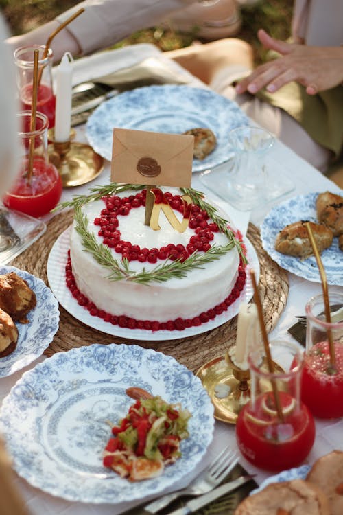 White and Red Floral Cake on Table