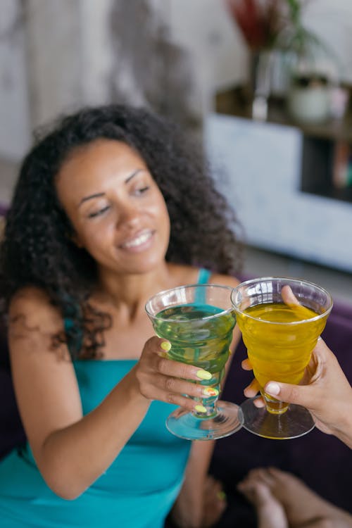 Women Cheering with Drinks at a Party