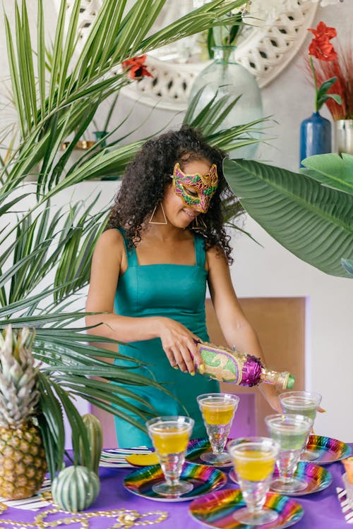 Woman Fixing Cocktail Drinks in a Masquerade Party