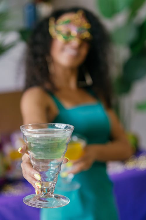 Cocktail Glass in a Smiling Womans Hand
