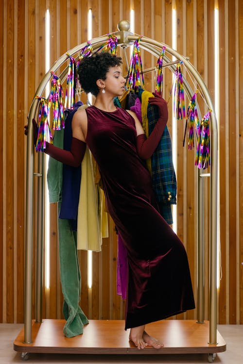 Woman Posing with a Clothing Rack