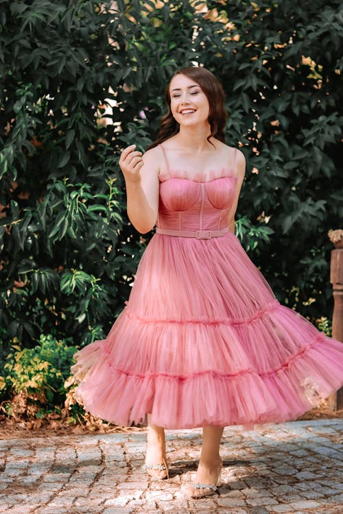A Happy Woman in a Pink Dress