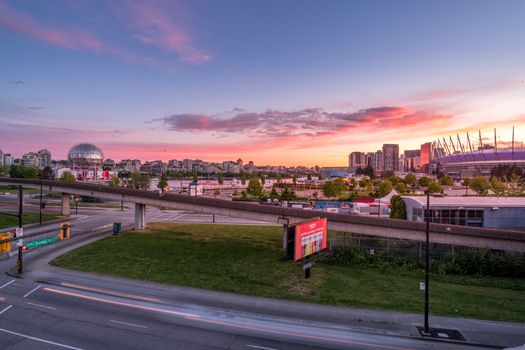 Stunning sunset view of Vancouver cityscape with elevated roads and Science World.