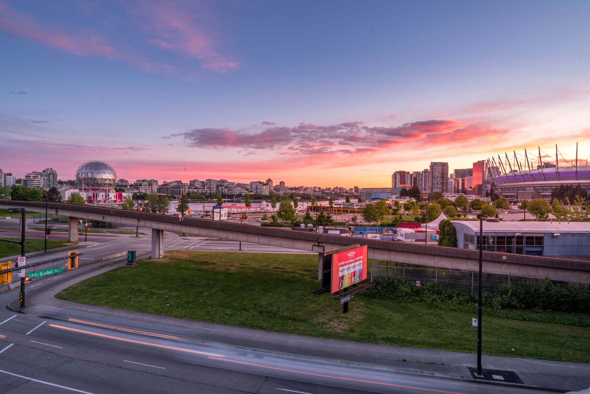 Stunning sunset view of Vancouver cityscape with elevated roads and Science World.