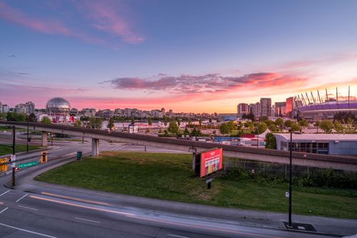 Free Stunning sunset view of Vancouver cityscape with elevated roads and Science World. Stock Photo