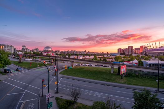 A stunning aerial view of Vancouver at sunset featuring the city's skyline and roads.