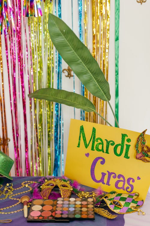 Makeup and a Mardi Gras Sign on a Table