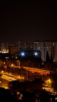 A vibrant cityscape at night showcasing brightly lit buildings and streets.