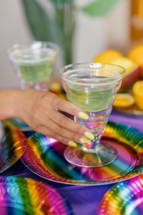 Free Bright and colorful party setup with citrus drinks and vibrant decorations, perfect for summer celebrations. Stock Photo