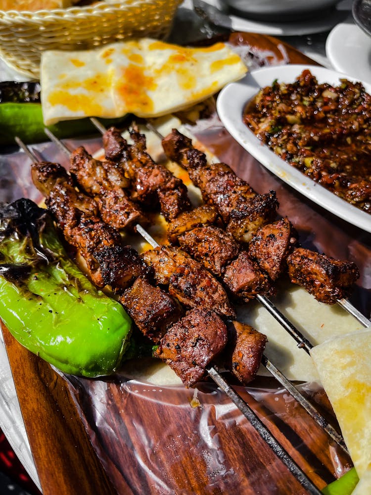 Photograph Of Grilled Meat In Metal Skewers