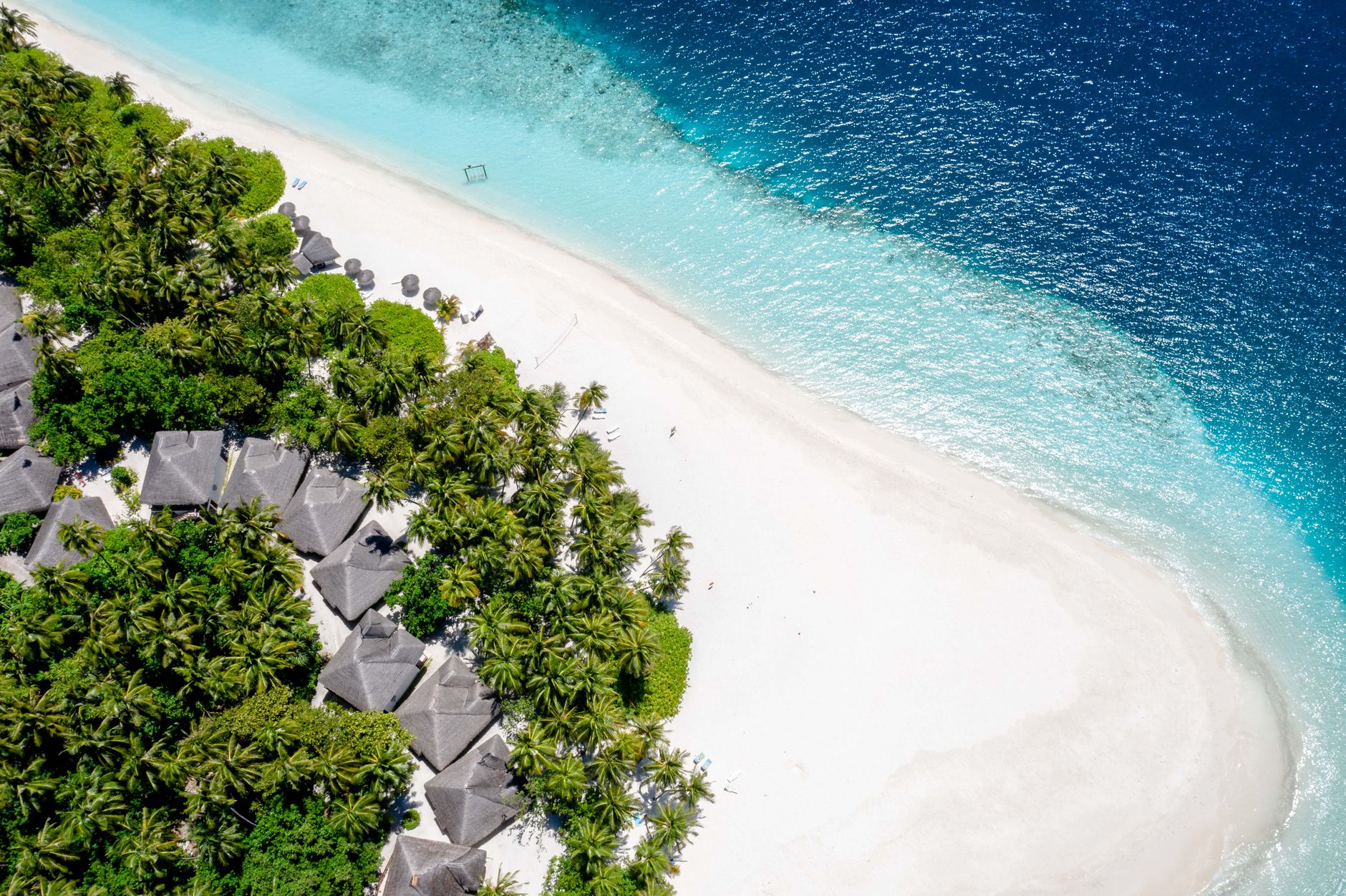 A stunning aerial view of a tropical beach in Kaafu Atoll, Maldives with turquoise water.