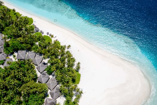 A stunning aerial view of a tropical beach in Kaafu Atoll, Maldives with turquoise water.
