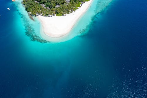 Aerial View of an Island Near a Blue Ocean