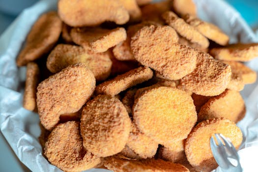 A close-up view of delicious crispy breaded chicken nuggets in a bowl, perfect for snacking.