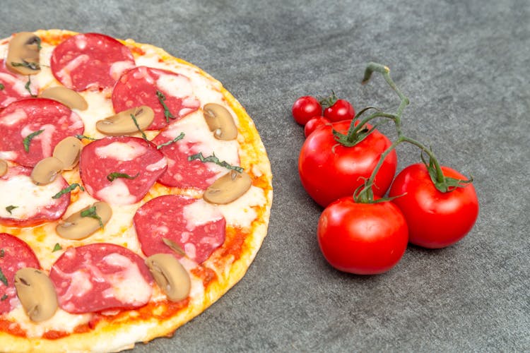 Pepperoni Pizza And Fresh Tomatoes