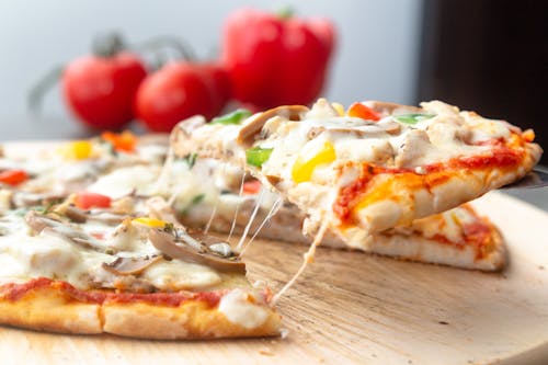 Pizza on Brown Wooden Board