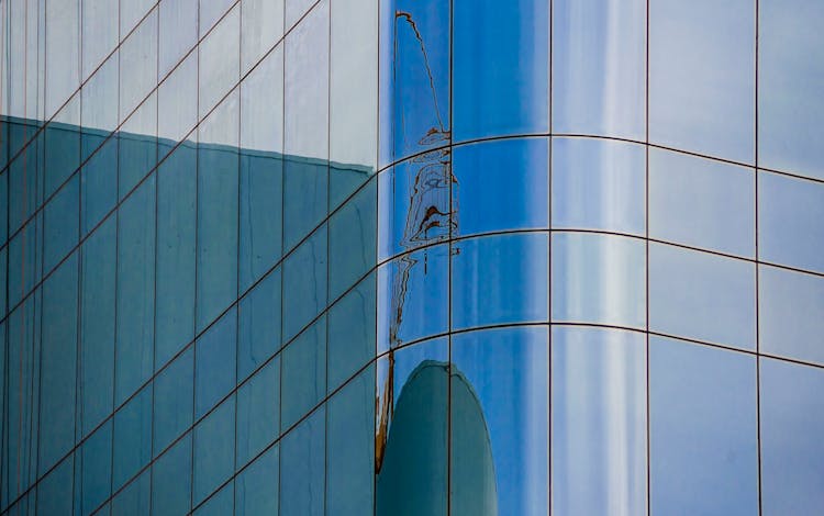 Glass Reflection Creating Shapes On Exterior Building Wall