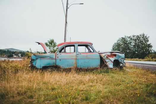 Vintage Teal Car on Green Grass Field