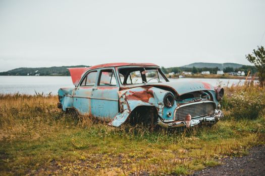 Blue and White Vintage Car on Green Grass Field