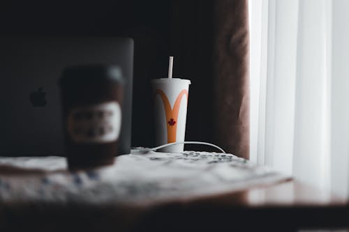 Cups of Takeout Drinks on Table by Laptop