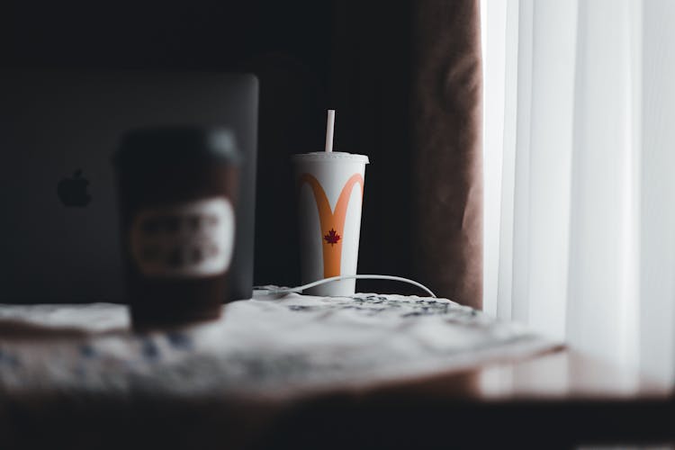 Cups Of Takeout Drinks On Table By Laptop