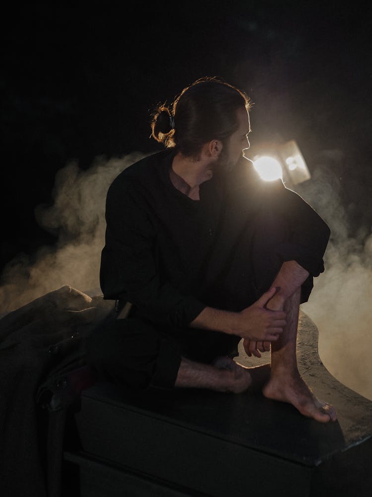 Man Sitting On Piano Surrounded By Smoke