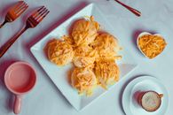 Bread With Cheese Toppings on a Ceramic Plate
