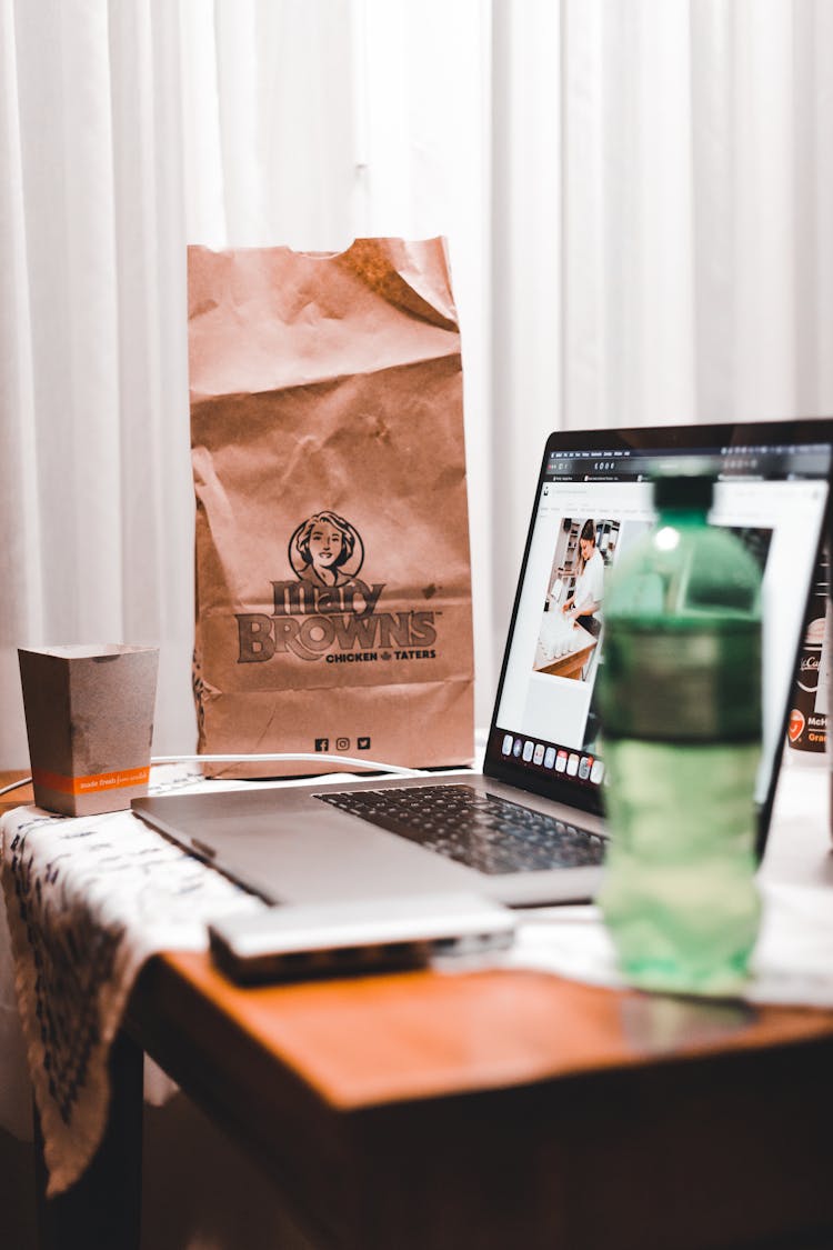 Takeaway Delivery Bag On Desk Near Laptop