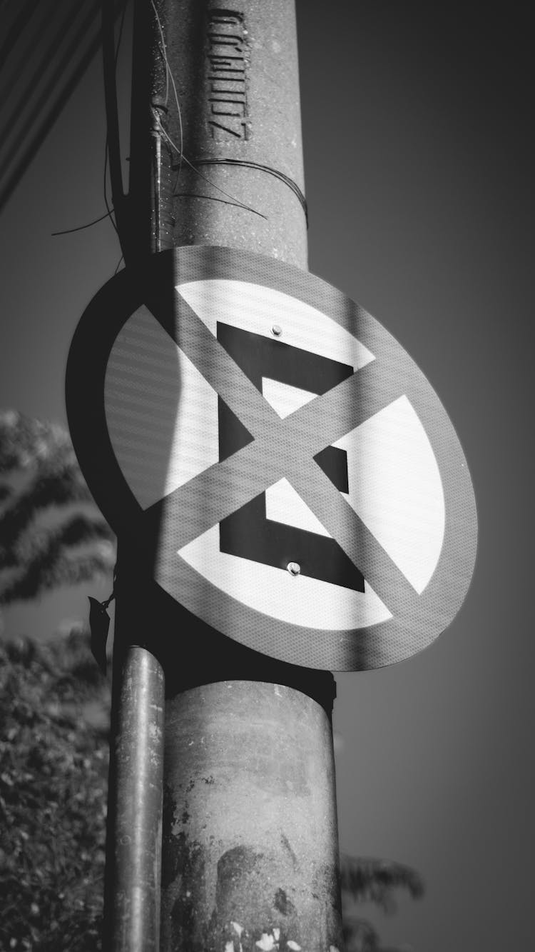 Warning Road Sign On Street Pillar