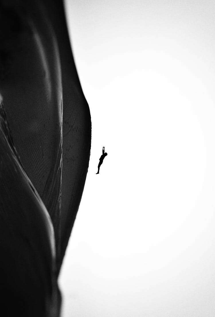 Grayscale Photo Of A Person Falling