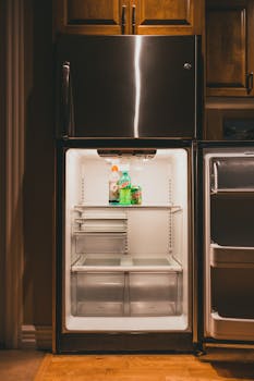 A vertically shot open refrigerator displaying Gatorade and Mountain Dew indoors.