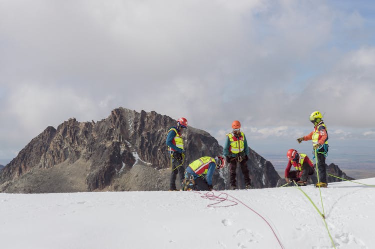 Team Of Explorers In The Snow Covered Mountain