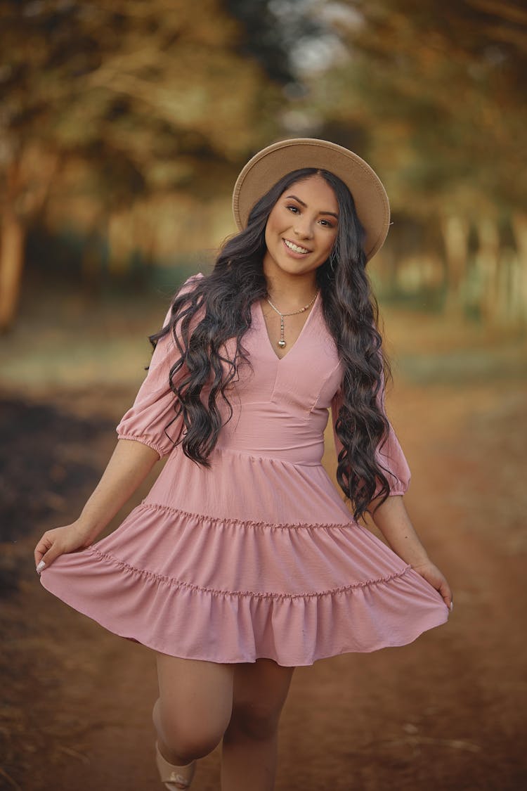 Woman In Dress And Hat Posing In Autumn Park