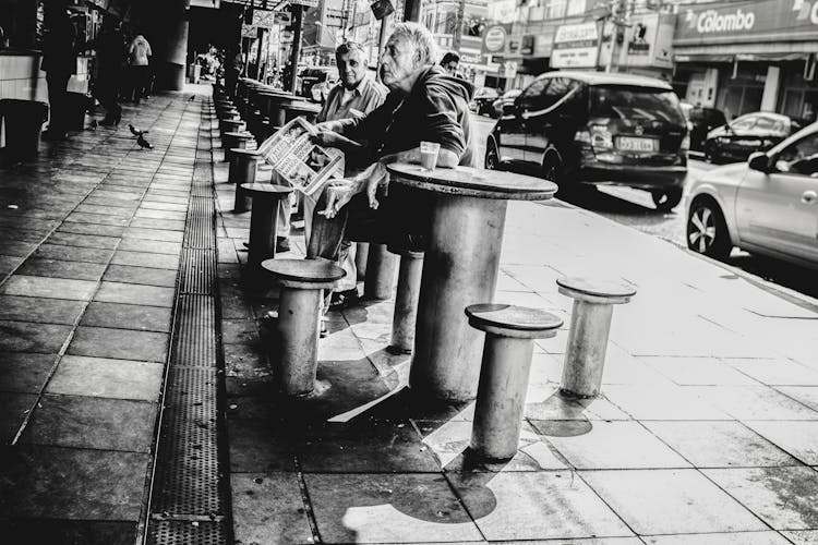 Old Men At Cafe Table On Street