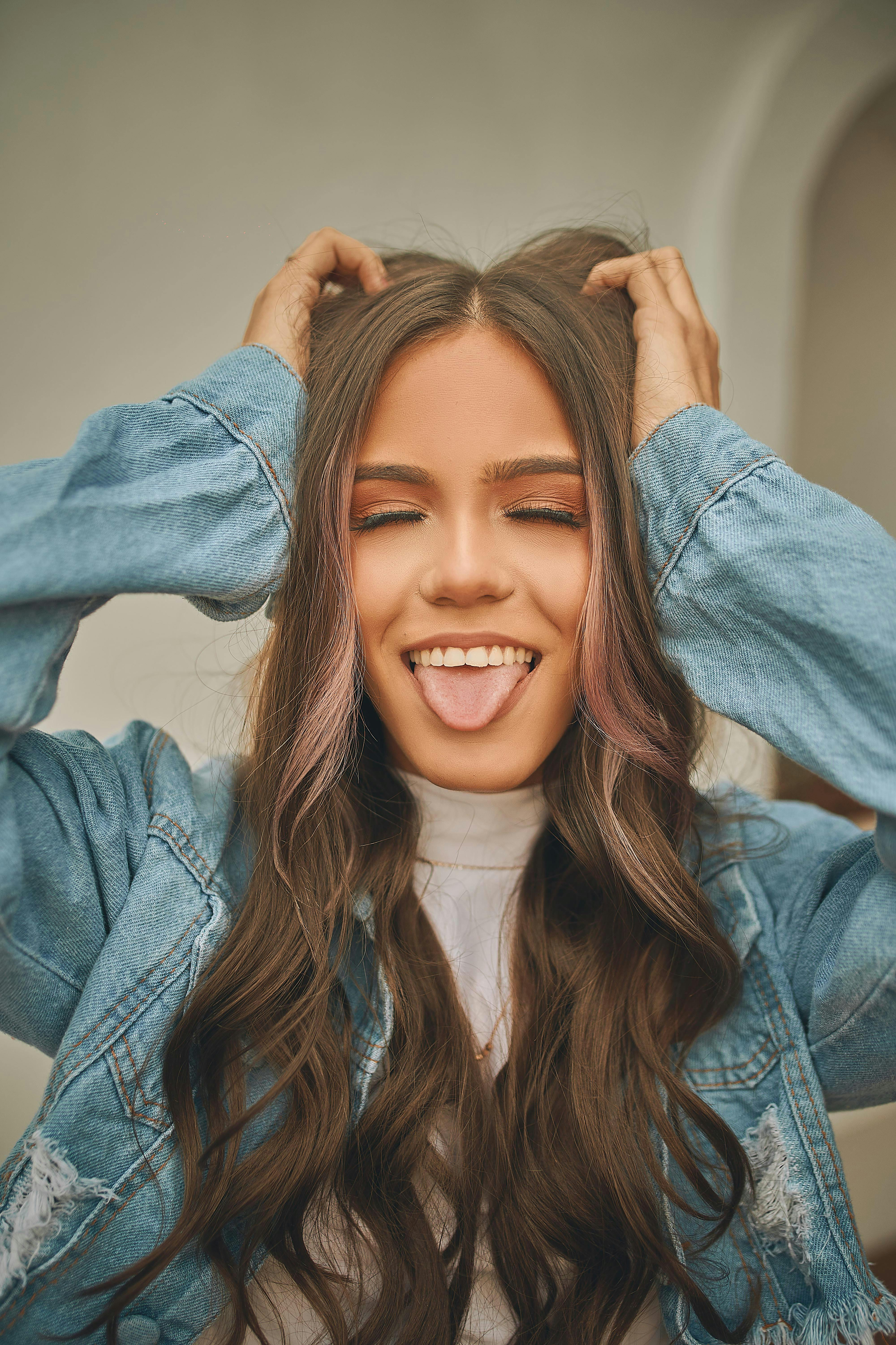 Woman Closed Eyes Showing her Tongue Free Stock Photo